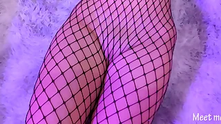 Asian in fishnet gives a footjob and gets cum all over her pussy